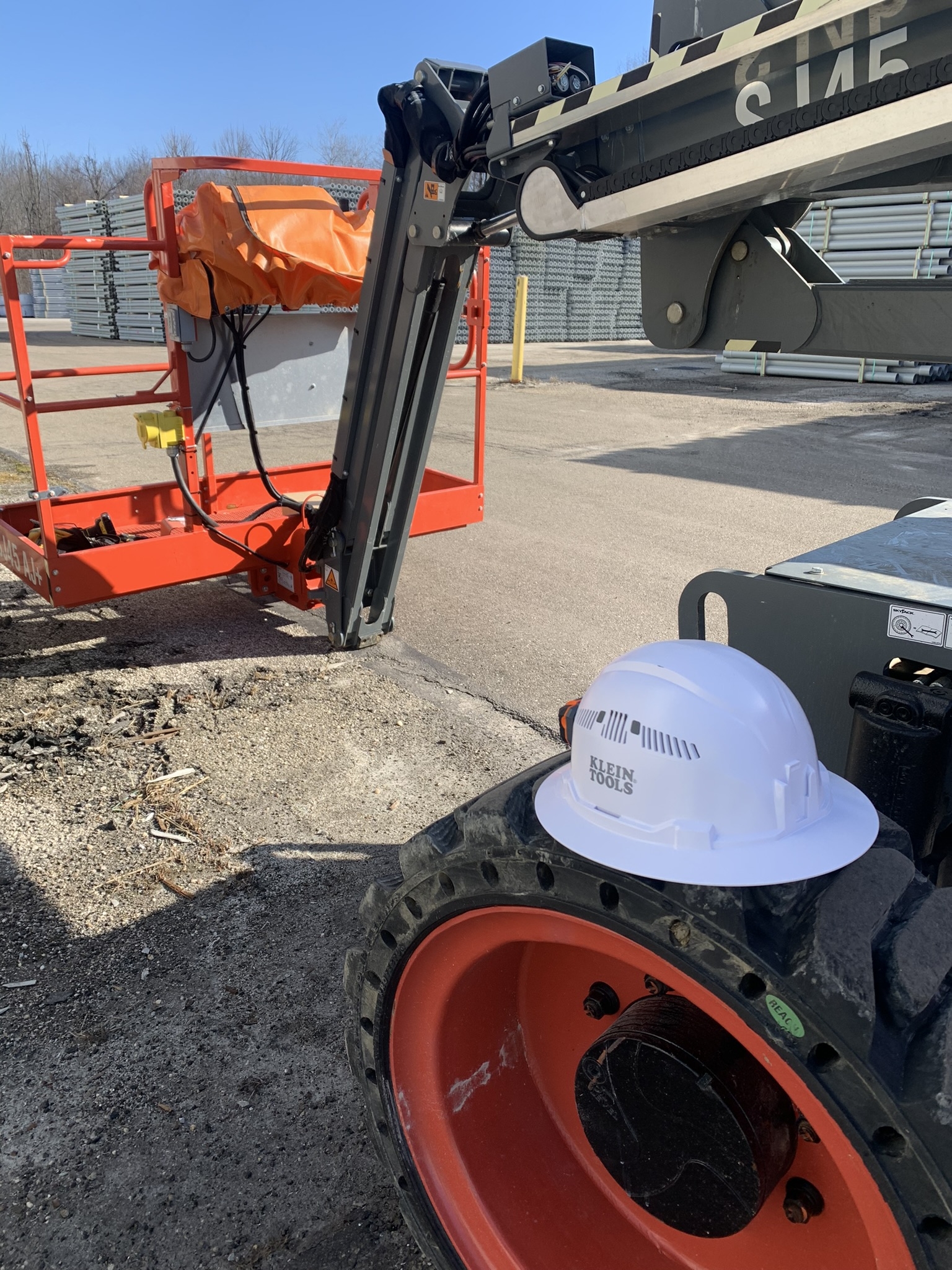 Staged boom lift and hardhat for on-site deployment