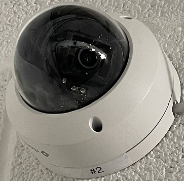 Hidden-face camera angle at a retail entrance and exit